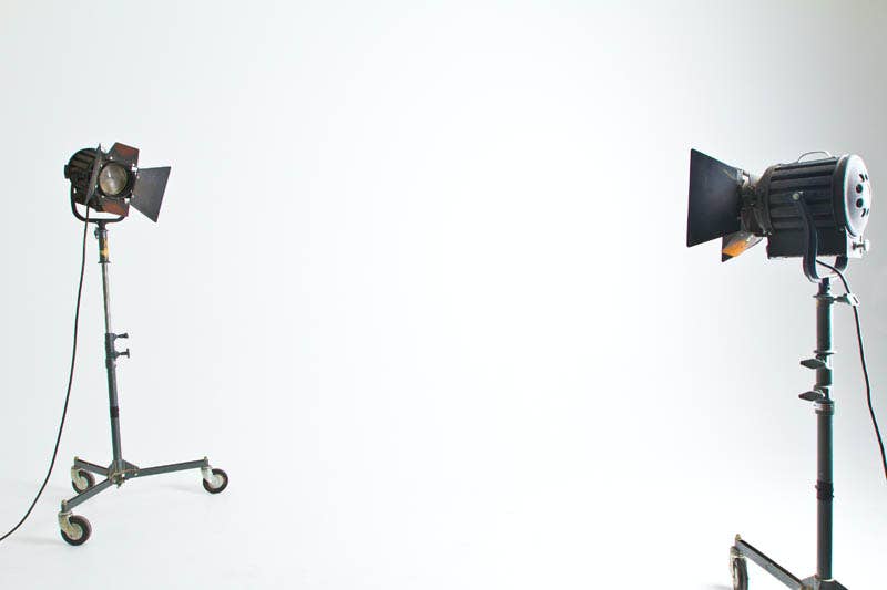 Overhead flat-lay of a home YouTube video lighting setup with LED lights and a camera on a desk