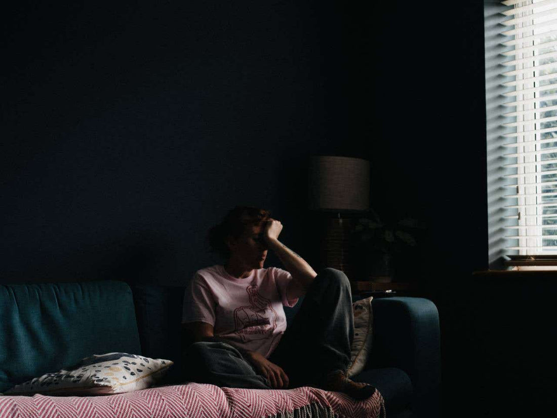 Photographer shooting indoors by a window in winter with soft natural light