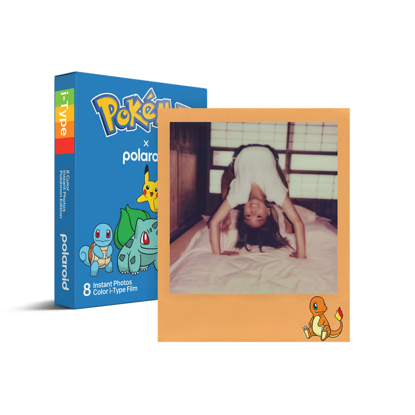 Pokémon x Polaroid i-Type film packaging shown beside an example instant photo print on a clean white background. The box is blue with Pokémon branding and character illustrations, and the photo print has a tan border with a vintage-style indoor snapshot of a person upside down on a bed.