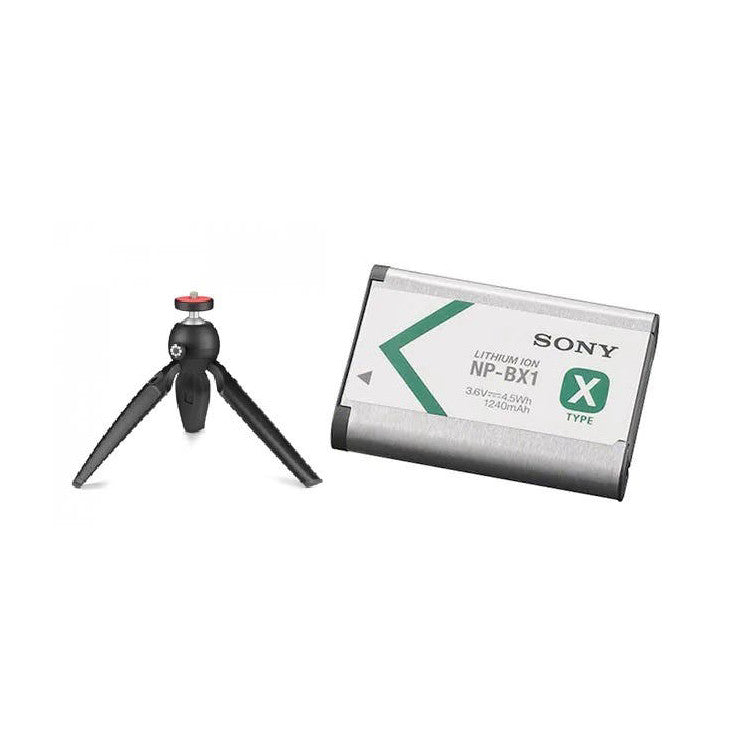 Sony NP-BX1 lithium-ion battery next to compact black Joby Handypod tripod with red ball head against white background.