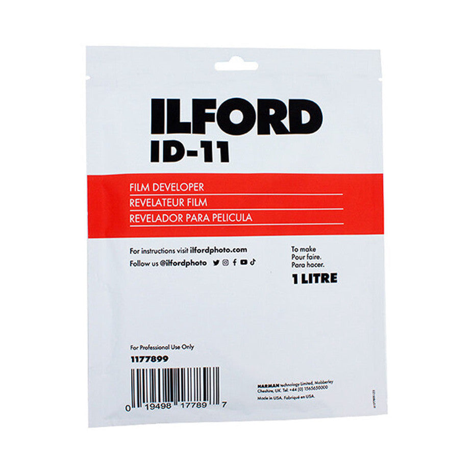 Front of Ilford ID-11 film developer packet showing red product band, instructions text, barcode, and 1 litre capacity marking against white background.