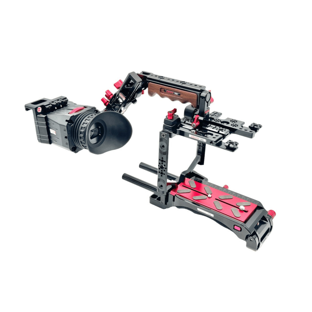 Professional video camera rig with black and pink components displayed at an angle, showing mounted camera on left and shoulder support cage with wooden handles on right.