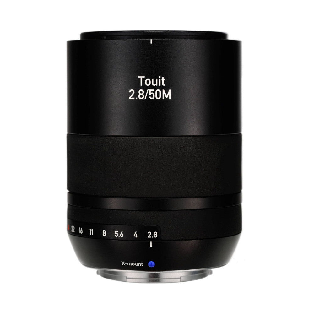 Black Zeiss Touit 2.8/50M macro lens shown from front angle, displaying aperture ring with f-stop markings and X-mount connector at base.