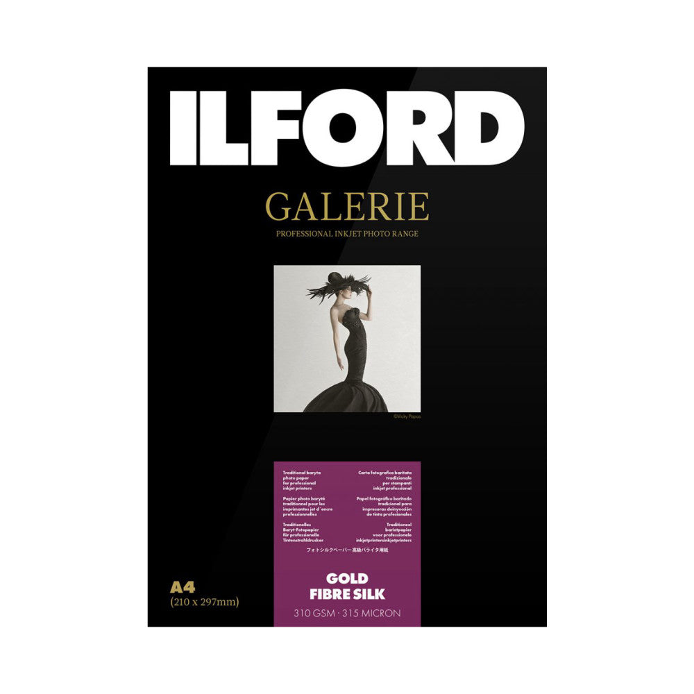 Product packaging front showing Ilford Galerie Gold Fibre Silk paper box with elegant fashion photography of woman in black dress against white background.