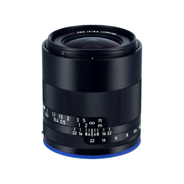 Black Zeiss Loxia 21mm f/2.8 lens with blue ring at base, shown from front angle against white background, displaying focus and aperture rings.