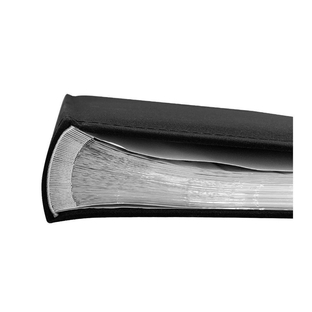 Close-up side view of an open black photo album showing white pages fanned out to display capacity and binding detail.