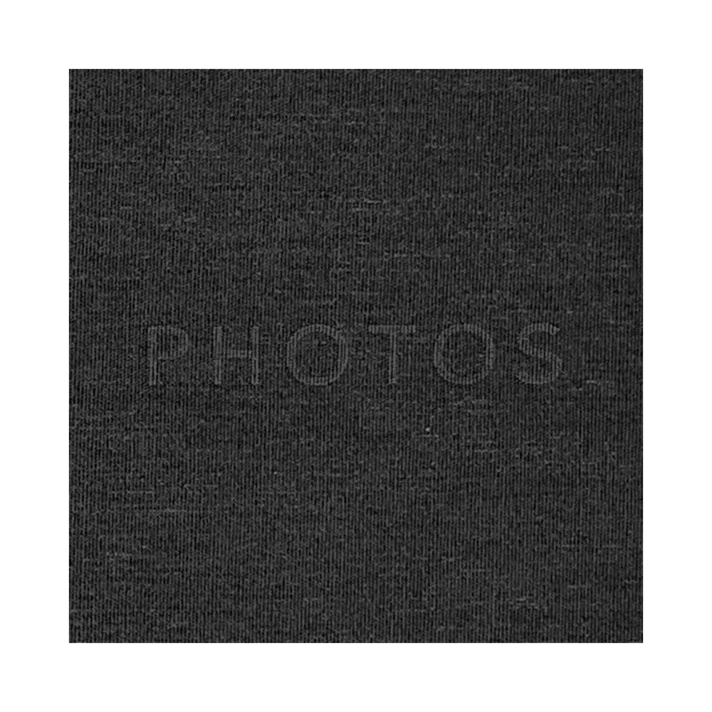 Close-up of black textured fabric surface showing ribbed weave pattern of photo album cover