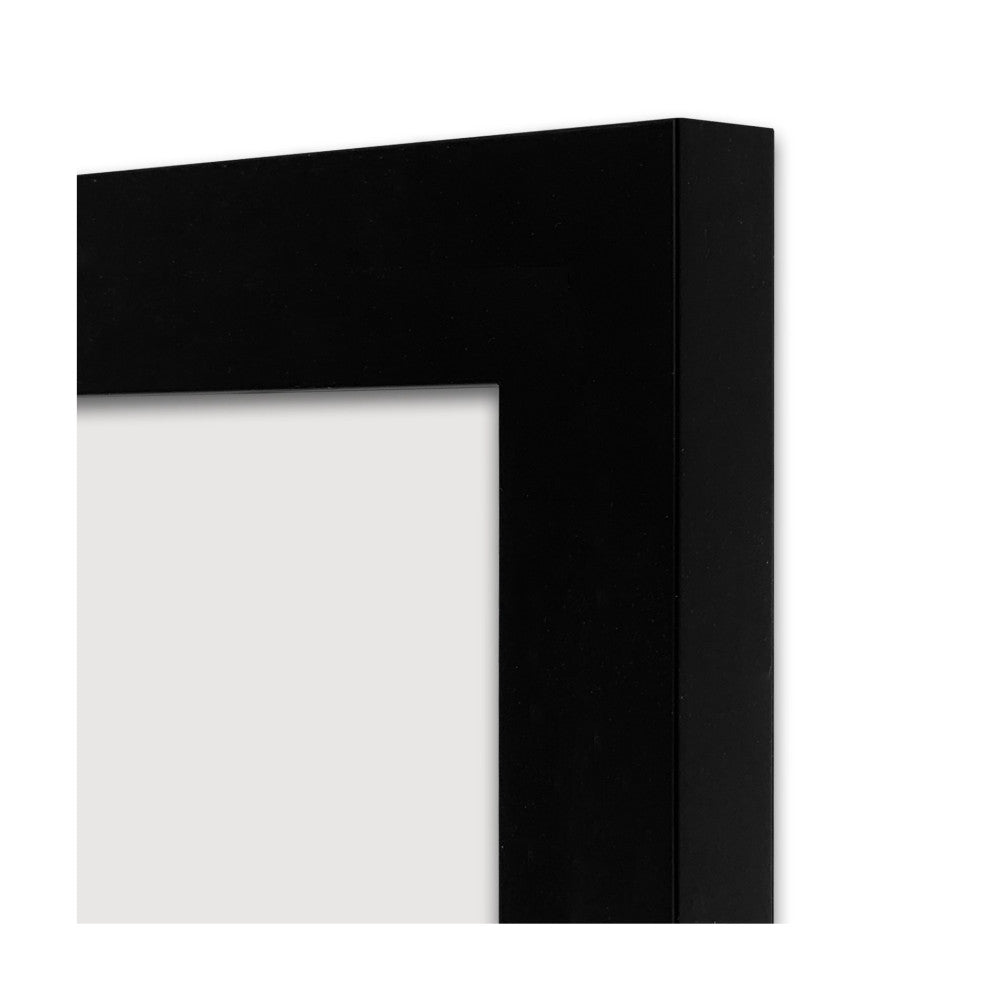 Close-up detail of black picture frame corner showing profile edge and white mat opening against white background.