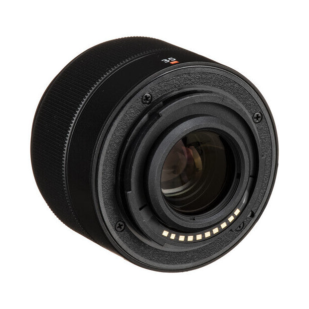 Rear view of black Fujifilm XC 35mm f/2 lens showing mount contacts and focus ring against white background.