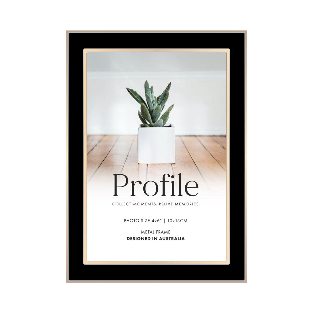 Front view of a black and rose gold metal photo frame displaying a cactus plant in a white pot on wooden flooring.