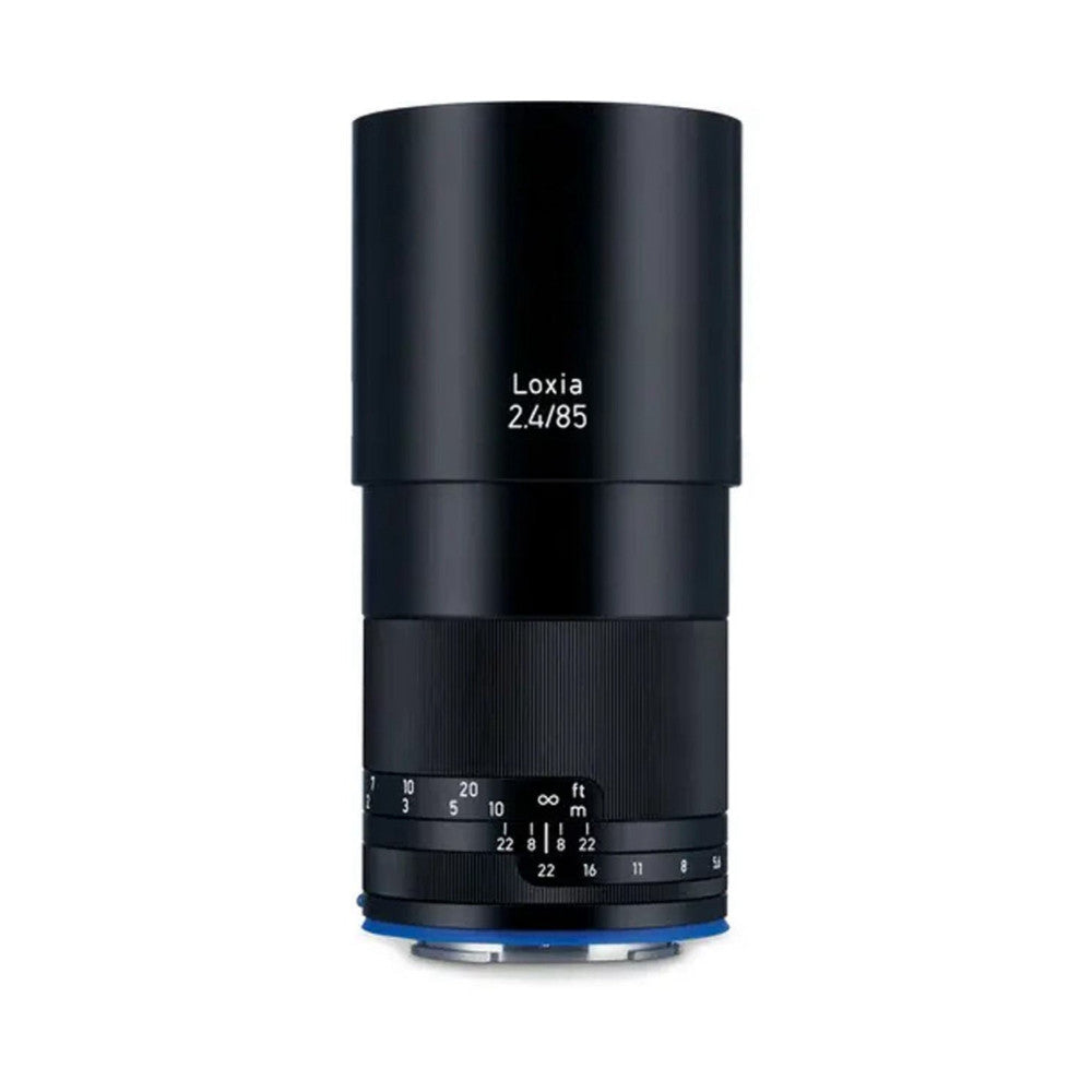 Black cylindrical camera lens shown from front view with focus ring and distance scale visible, blue Sony E-mount base at bottom.