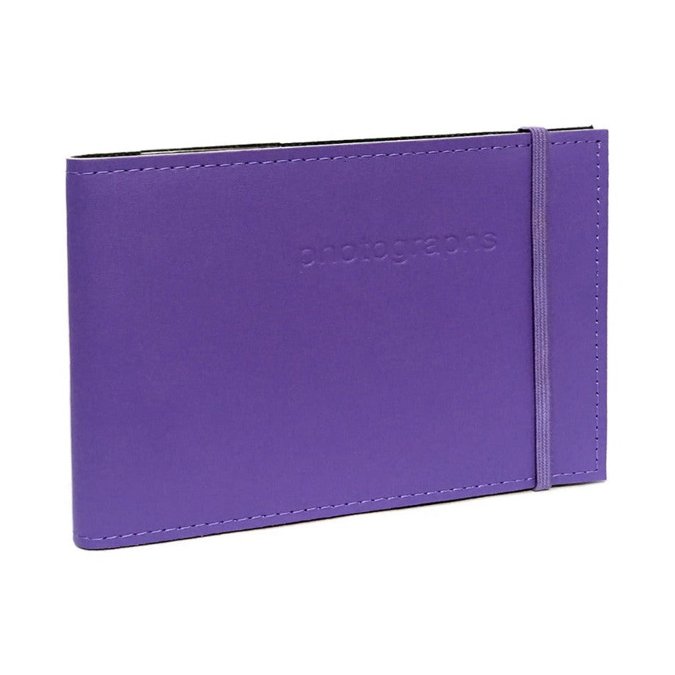 Purple leather photo album displayed at an angle, showing the front cover with embossed branding and elastic closure band on the right side.