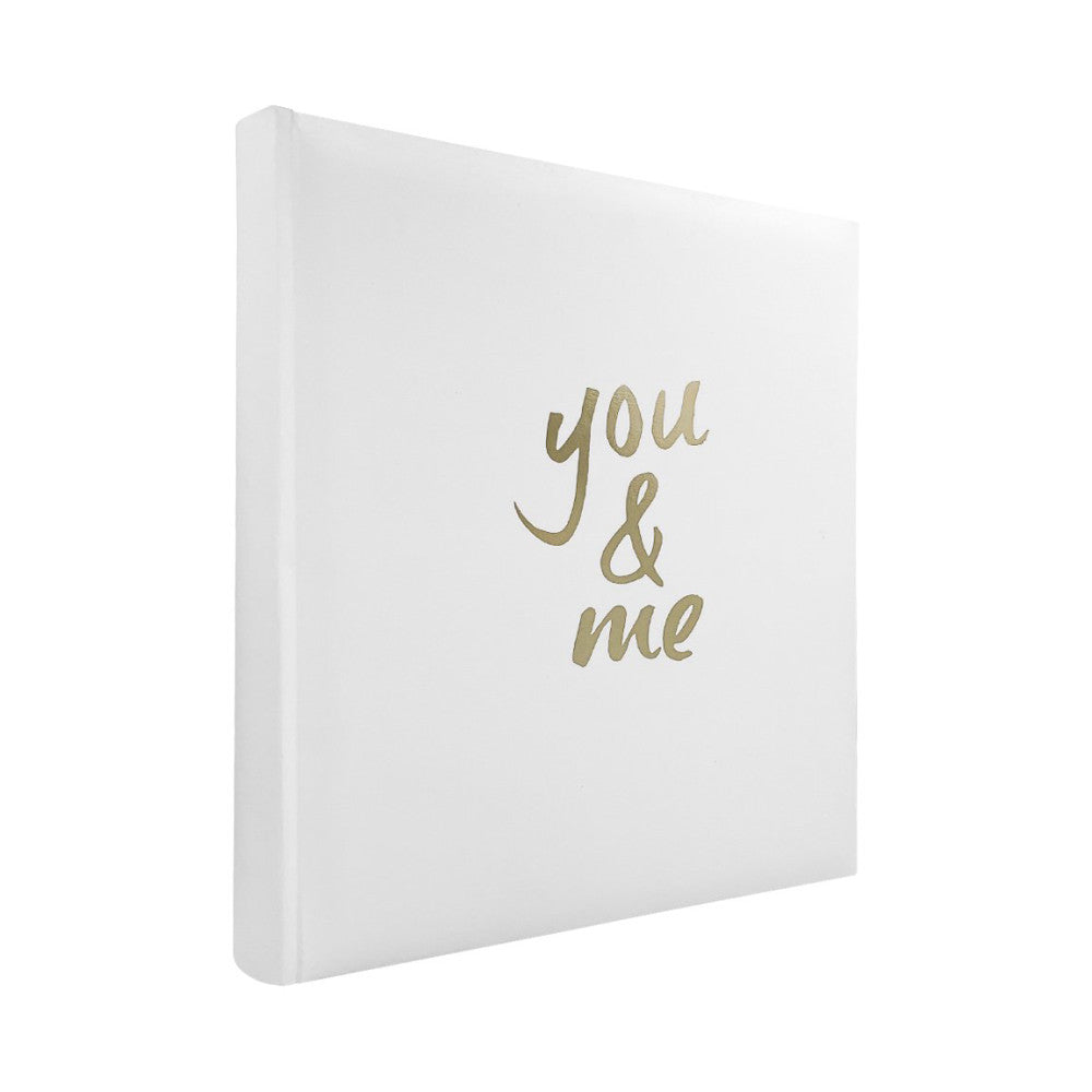 White slip-in photo album shown at an angle displaying the front cover with gold "you & me" text and visible spine.