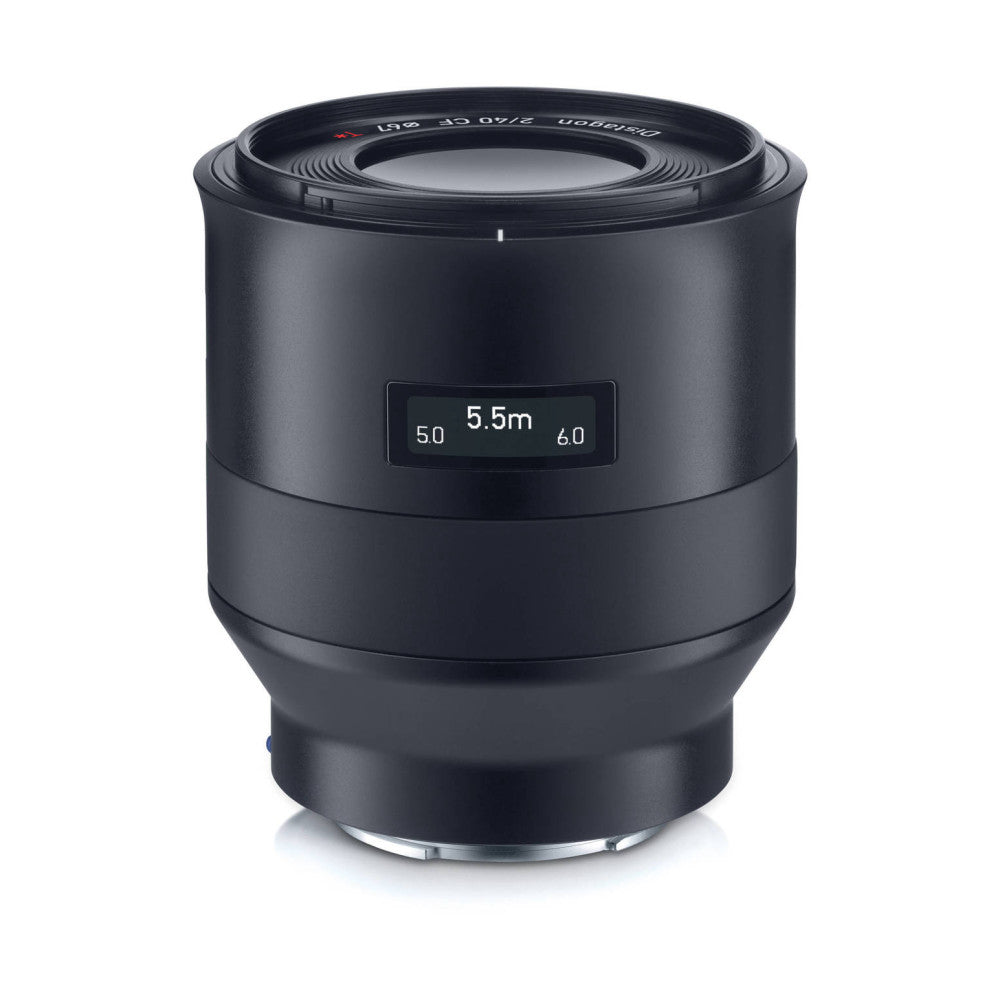 Black cylindrical camera lens shown from front angle, displaying 5.5m focus distance on LCD screen and f/2.0 aperture marking on barrel.