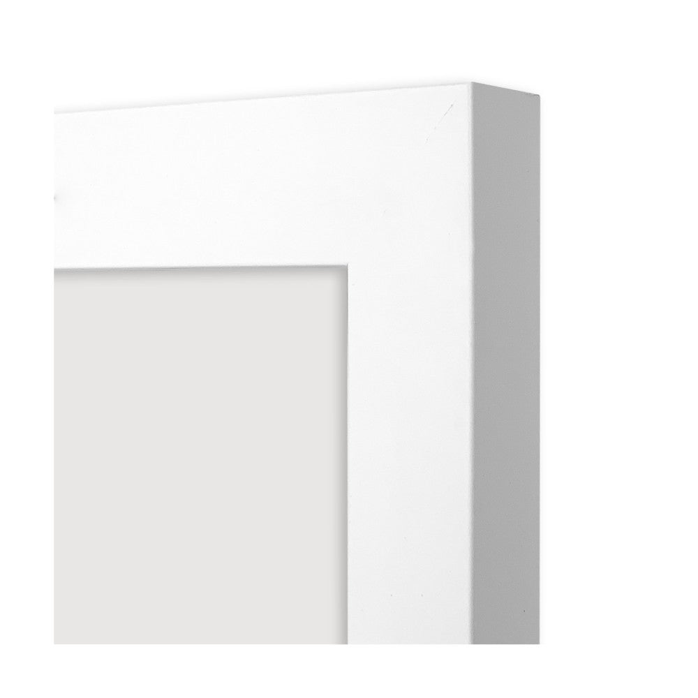 Close-up side view of white timber picture frame showing depth and profile of the frame edge against white background