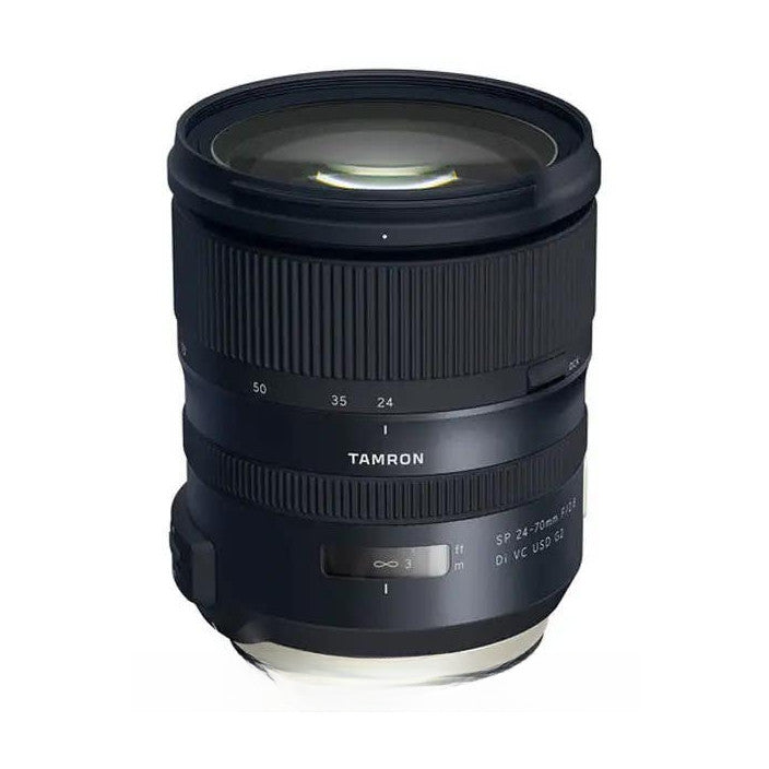 Black Tamron zoom lens shown at angle against white background, displaying focal length markings and control rings