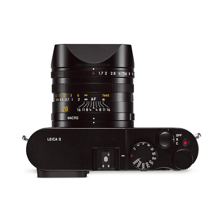 Top-down view of black Leica Q camera showing lens, body, controls, and viewfinder area with exposure dial visible.