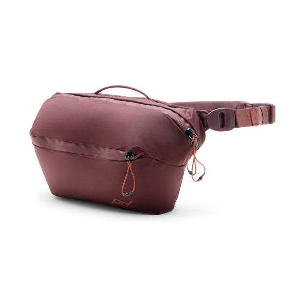 Peak Design Everyday Sling 4L in Eclipse burgundy shown from side angle against white background, displaying main compartment with zipper and adjustable shoulder strap.