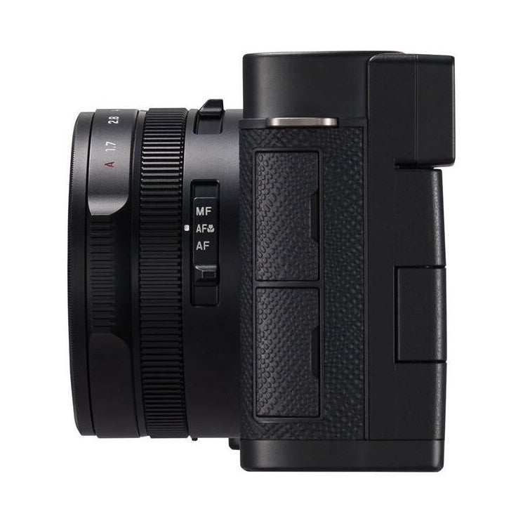 Side view of black Panasonic Lumix L10 compact camera showing lens with focus mode controls and textured grip body against white background.
