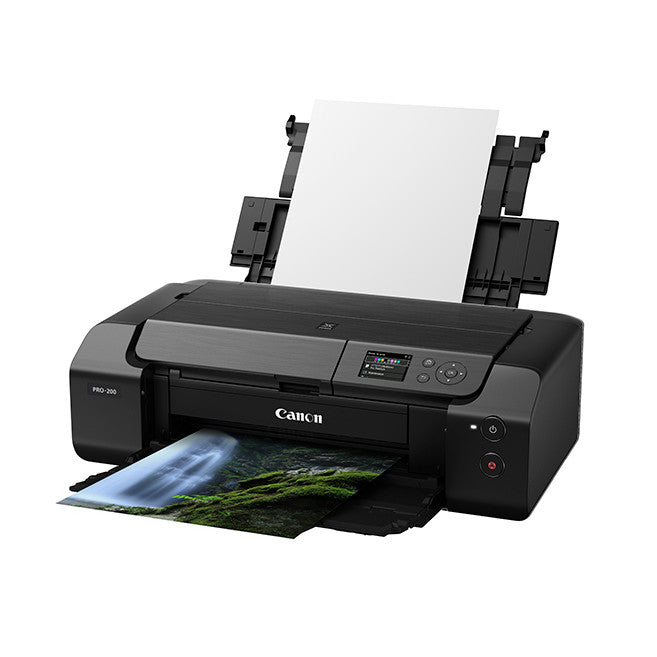 Canon Pro 200 A3+ printer shown from front-left angle with paper tray open and a landscape photo printing.