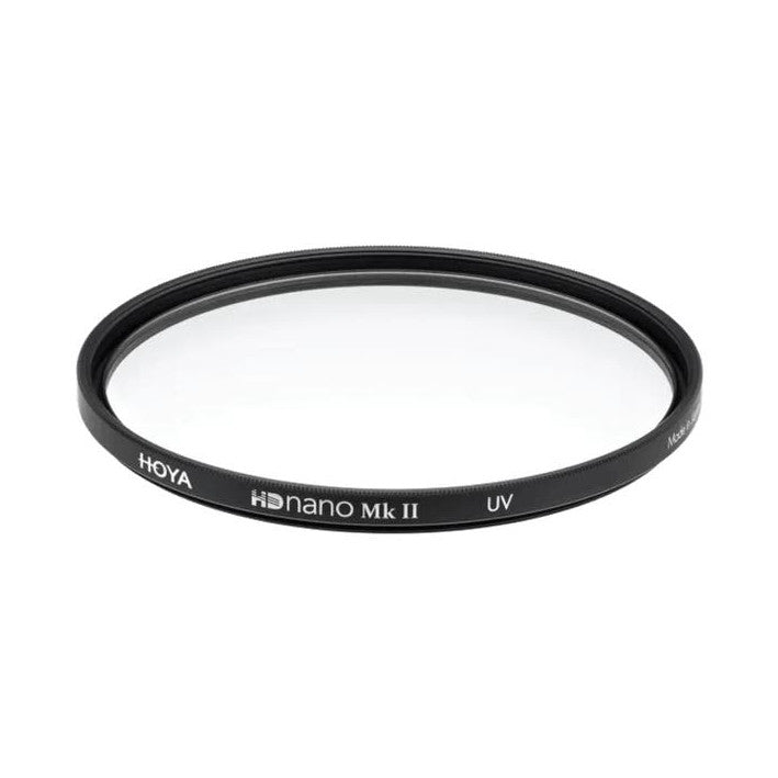 Circular black lens filter photographed at an angle against white background, showing text "HOYA HDnano Mk II UV" on the rim.