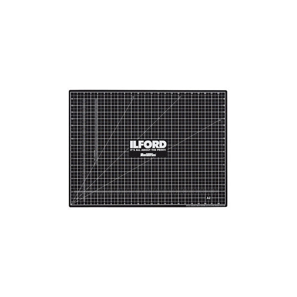 Black self-healing cutting mat with grid pattern and diagonal lines, Ilford RotaTrim branding visible in center, front view.