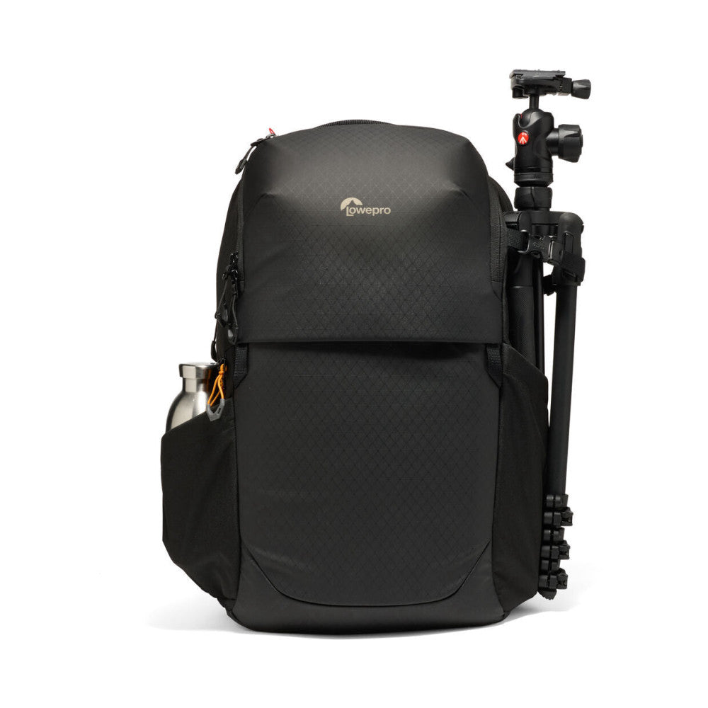 Black LowePro camera backpack shown from front view with attached tripod on right side and water bottle in side pocket.