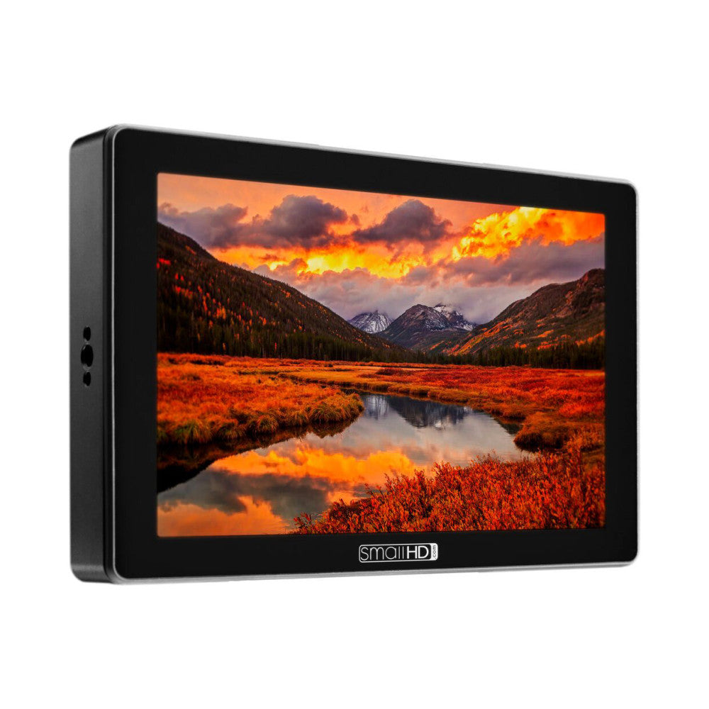 SmallHD CINE 7 monitor displaying a vibrant landscape photo of mountains and sunset, shown at three-quarter angle against white background.