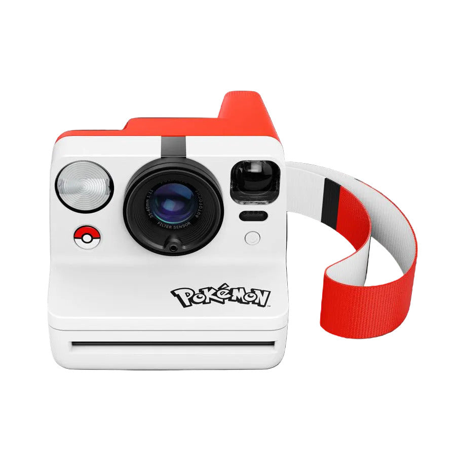 Front view of white Polaroid instant camera with red accents, Pokéball logo, and red carrying strap against black background.