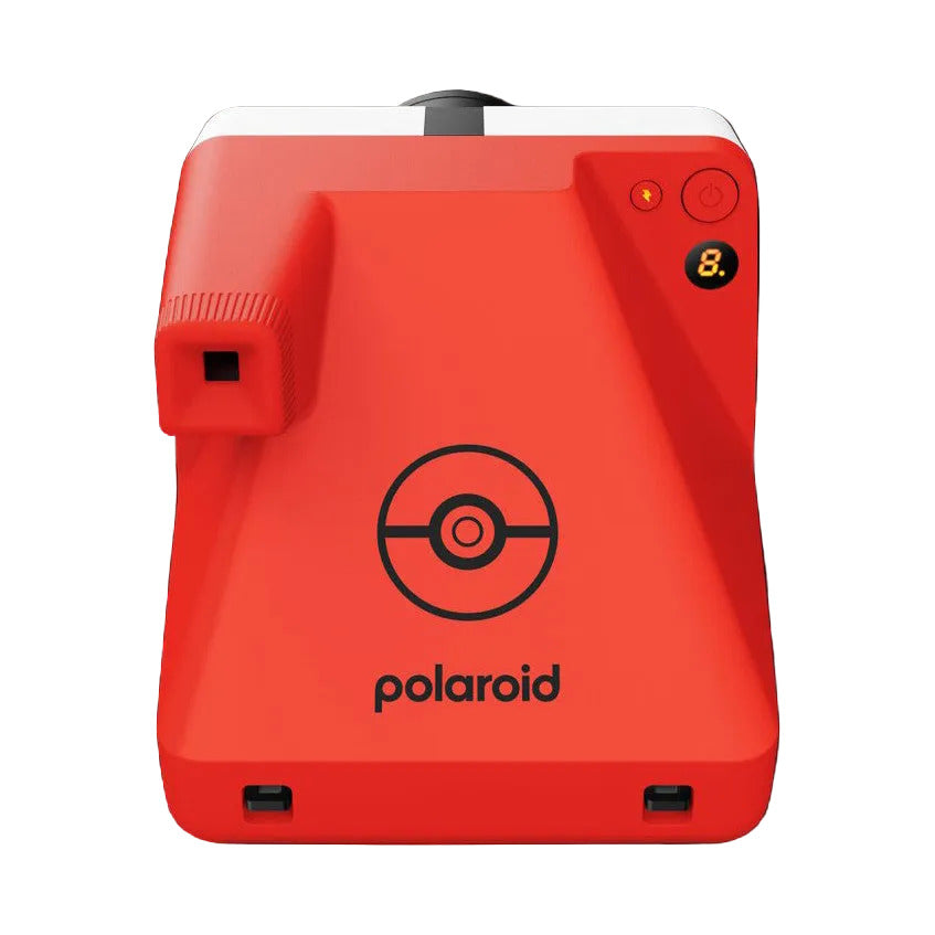 Red Polaroid instant camera shown from front view against black background, featuring circular Pokéball logo and control buttons on right side.