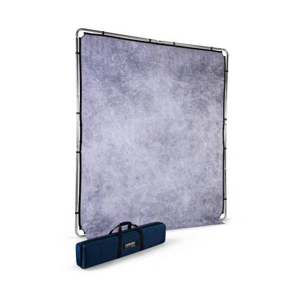 Lastolite EzyFrame background kit displayed at an angle, showing purple textured fabric panel with black frame and blue carrying case below.