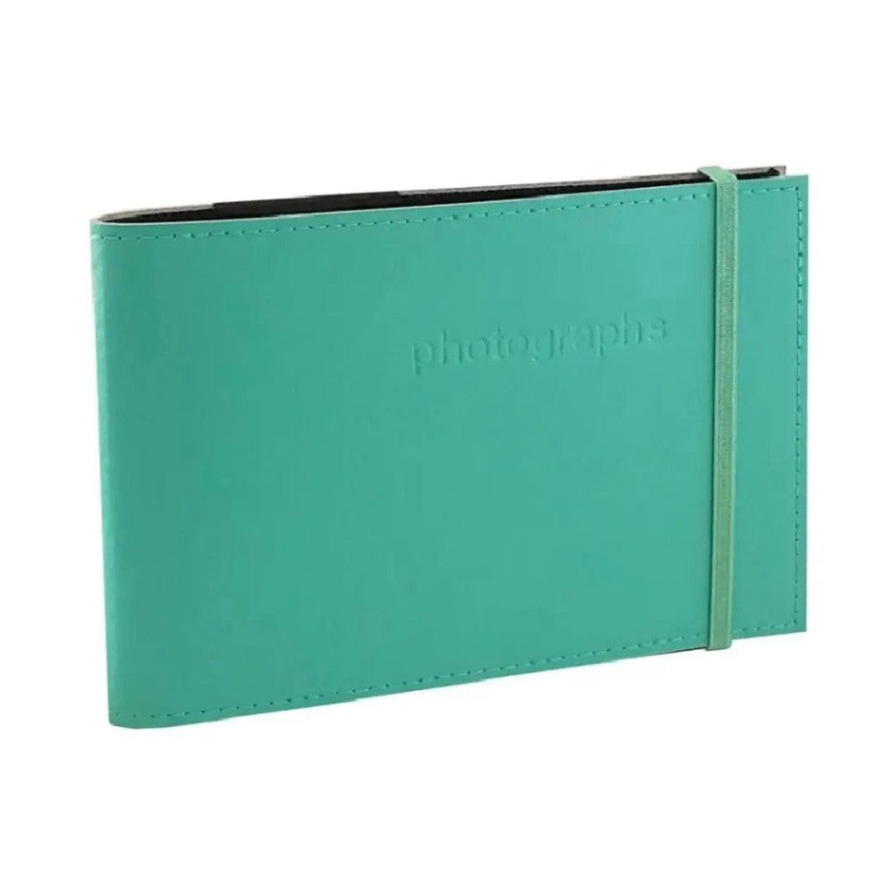 Turquoise leather photo album displayed at an angle, showing the front cover with embossed "photographs" text and elastic closure band on the right side.