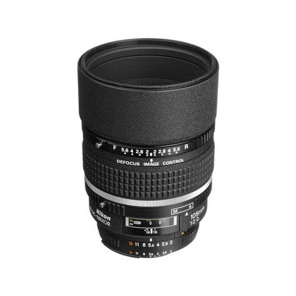 Black Nikon AF DC-NIKKOR 105mm telephoto lens shown from front angle against white background, displaying focus ring, aperture markings, and barrel detail.