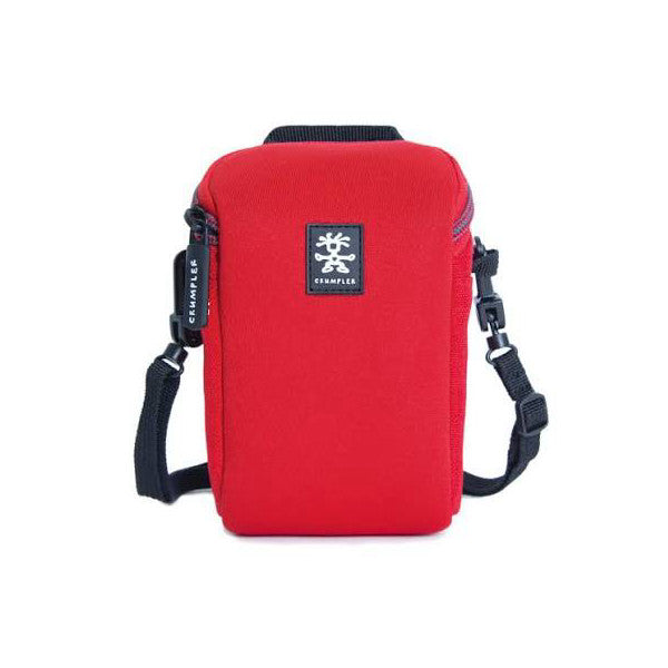 Front view of a red Crumpler Triple A 100 camera pouch with black accents, shoulder strap, and branded patch.
