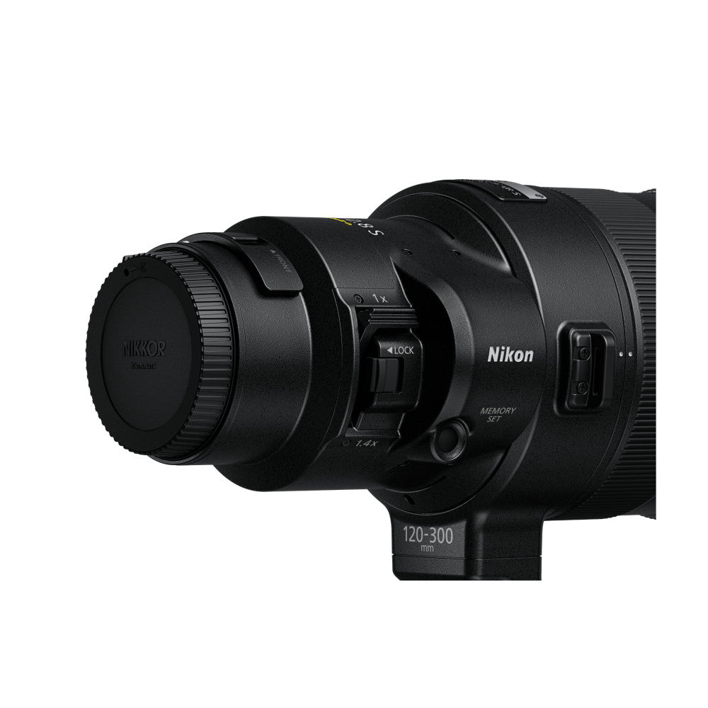 Side view of NIKKOR Z 120-300mm lens showing the barrel, focus ring, zoom markings, and built-in teleconverter mechanism against white background.