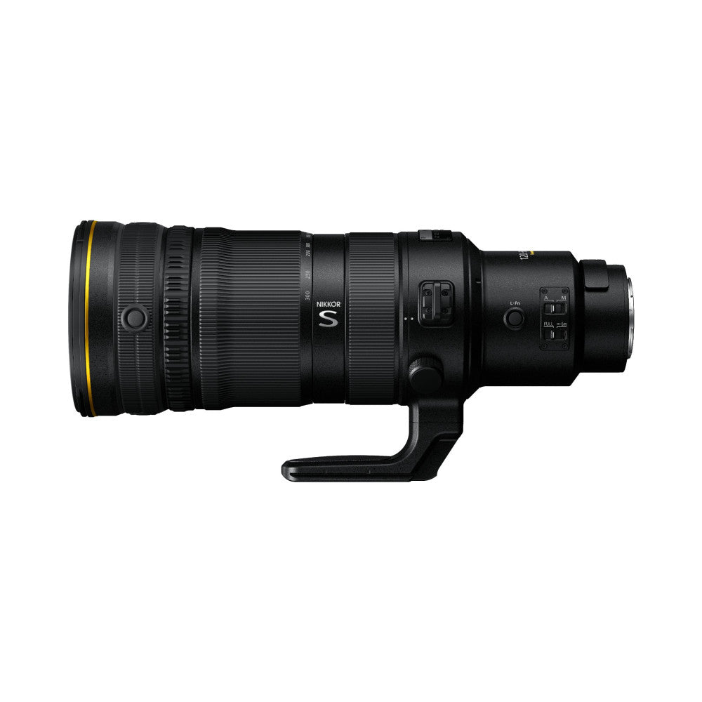 Side view of a black Nikkor Z telephoto lens with yellow accent ring, showing the barrel, control rings, and tripod foot against white background.