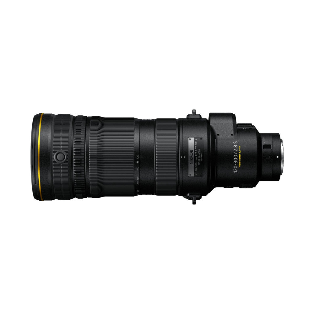 Side view of a black NIKKOR Z 120-300mm telephoto lens with yellow ring accent and built-in teleconverter, showing full barrel from front element to rear mount.