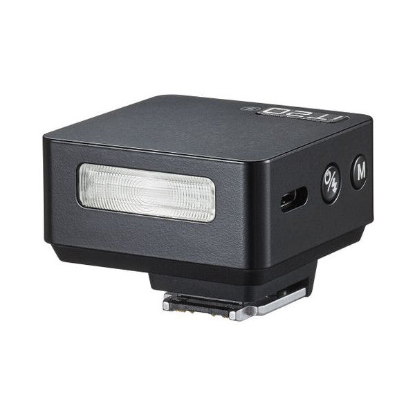 Compact black TTL flash unit shown from a three-quarter angle, displaying the front flash head with diffuser panel and side-mounted hot shoe connector.