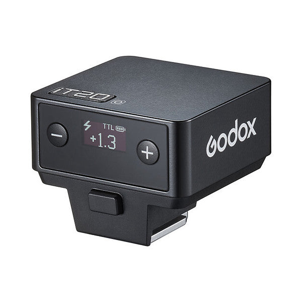 Godox iT20 mini flash shown from front-angled view, displaying control panel with TTL mode, +1.3 compensation dial, and +/- adjustment buttons.