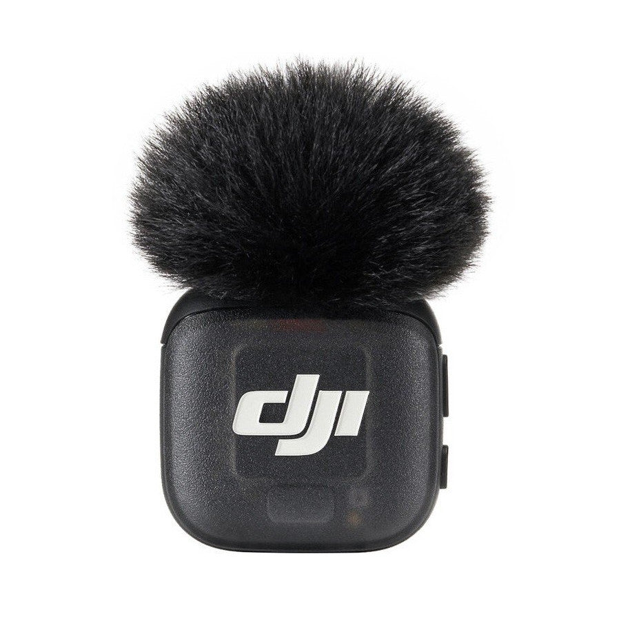 DJI MIC 3 TX transmitter front view showing black rectangular body with white DJI logo and attached black fuzzy windscreen windscreen.