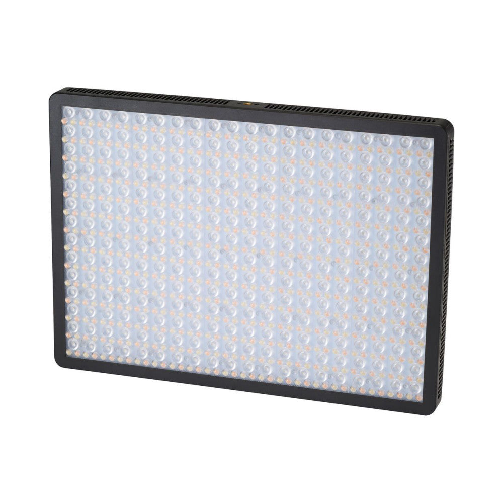 Angled front view of a black rectangular LED light panel displaying a grid of small round lens elements with warm amber and cool white lighting visible across the surface.