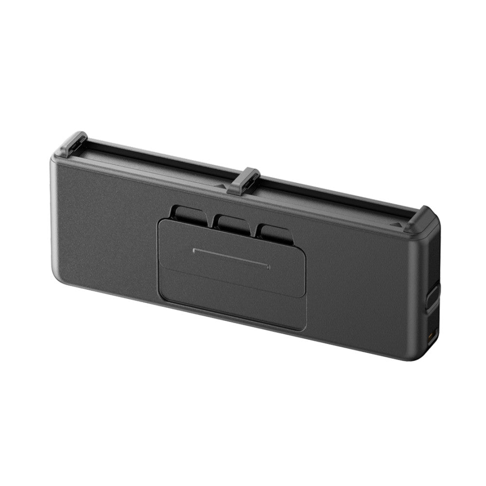 Black rectangular charging case shown at an angle, displaying the front panel with a recessed compartment and three raised tabs on top.