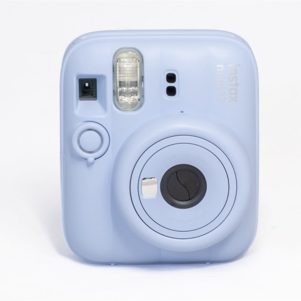 Front view of a light blue Fujifilm Instax Mini 13 instant camera showing the lens, flash, and shutter button against a white background.