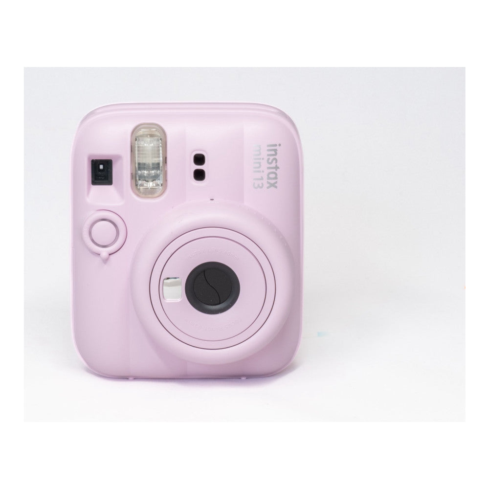 Front view of pink Fujifilm Instax Mini 13 instant camera showing lens, flash, shutter button, and viewfinder against white background.