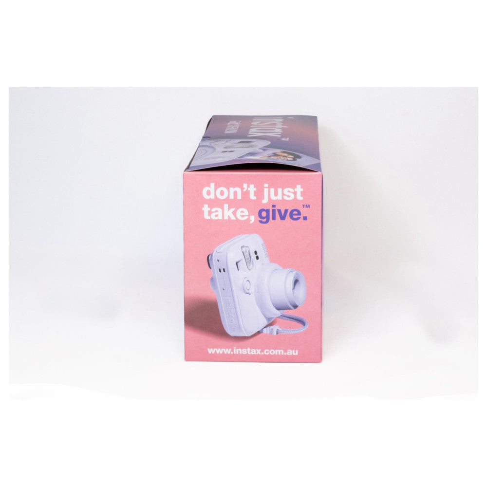 Product packaging box for Instax Mini 13 camera shown from front angle, displaying pink box with white camera image and "don't just take, give" tagline.