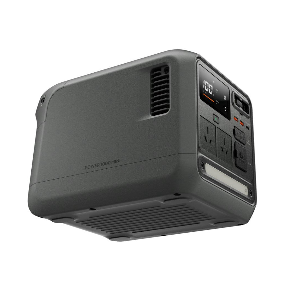 DJI Power 1000 Mini power station angled view showing front control panel with digital display and AC outlets, ventilation grilles, and compact gray design.