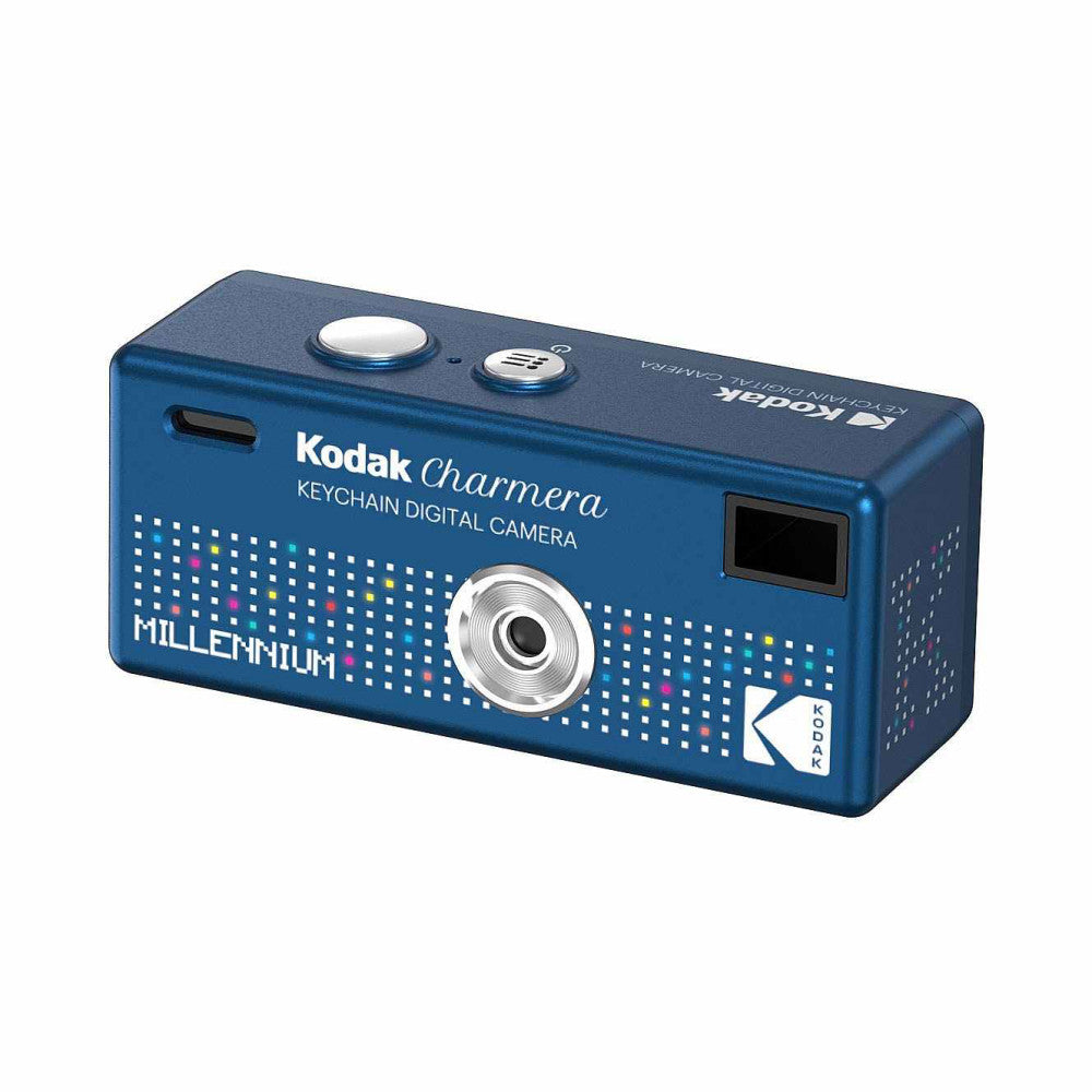 Blue rectangular Kodak Charmera Millennium keychain digital camera shown from three-quarter angle, displaying lens, controls, and dotted pattern design on front face.
