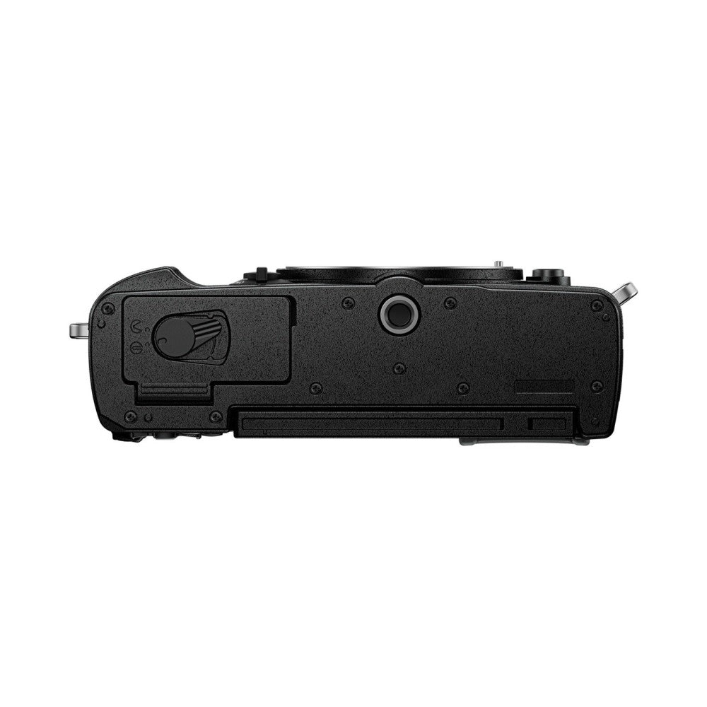 Top view of black OM System PEN camera body showing lens area, viewfinder, and control dial on textured surface.