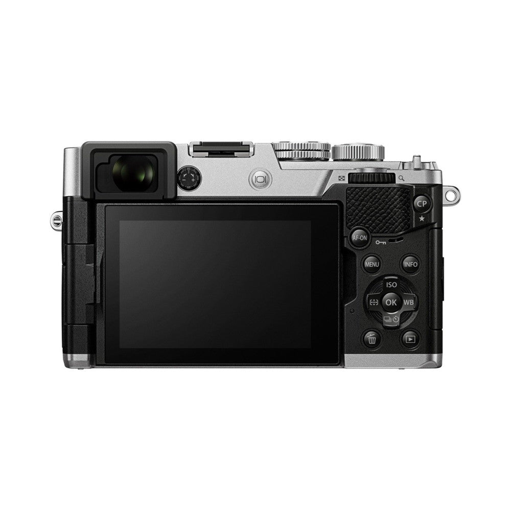 Rear and top view of a silver and black compact mirrorless camera with articulating LCD screen, showing lens, viewfinder, and control buttons.