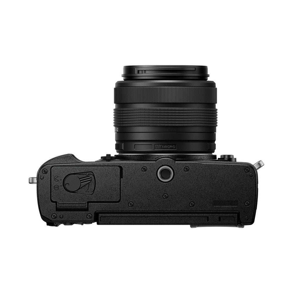Top view of black OM System PEN mirrorless camera with attached M.Zuiko 14-42mm lens against white background.
